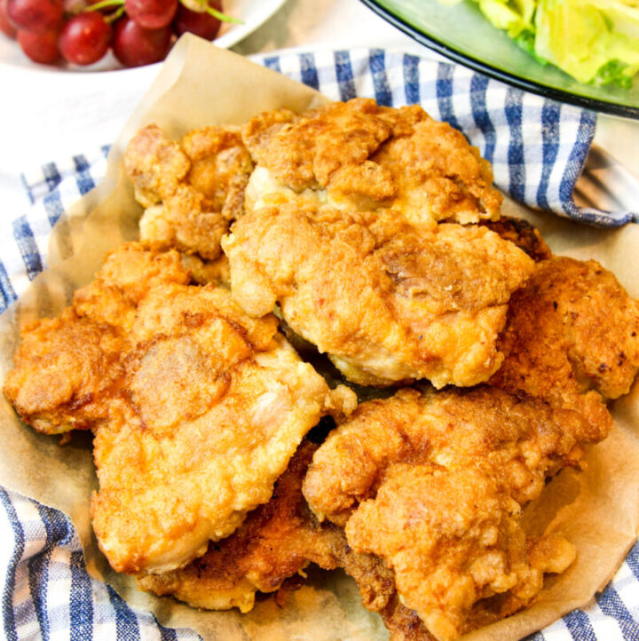 a plate and checkered napkin with piled high paleo fried chicken