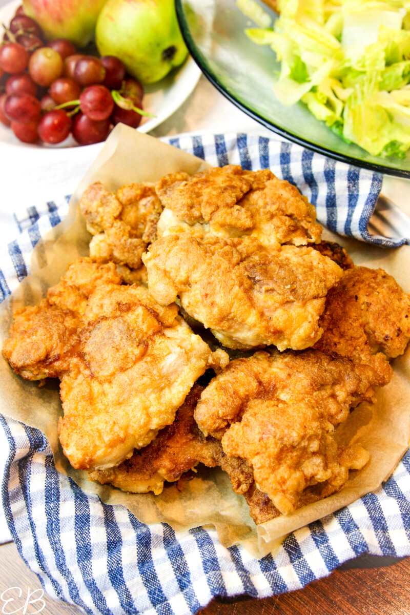 a plate and checkered napkin with piled high paleo fried chicken