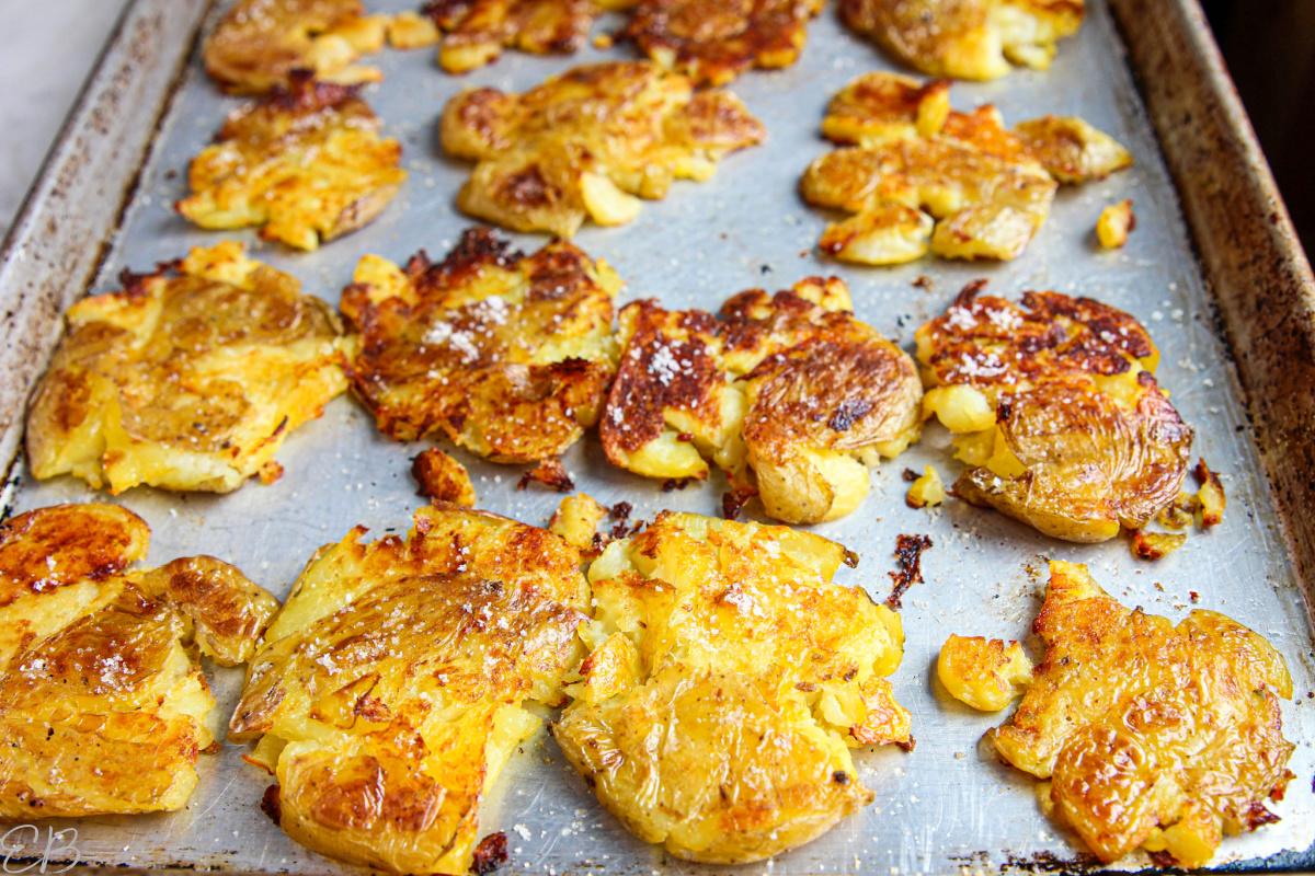 close up photo of small smashed potatoes roasted on sheet pan