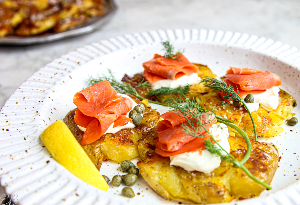 close up photo of smashed potatoes appetizer with smoked salmon