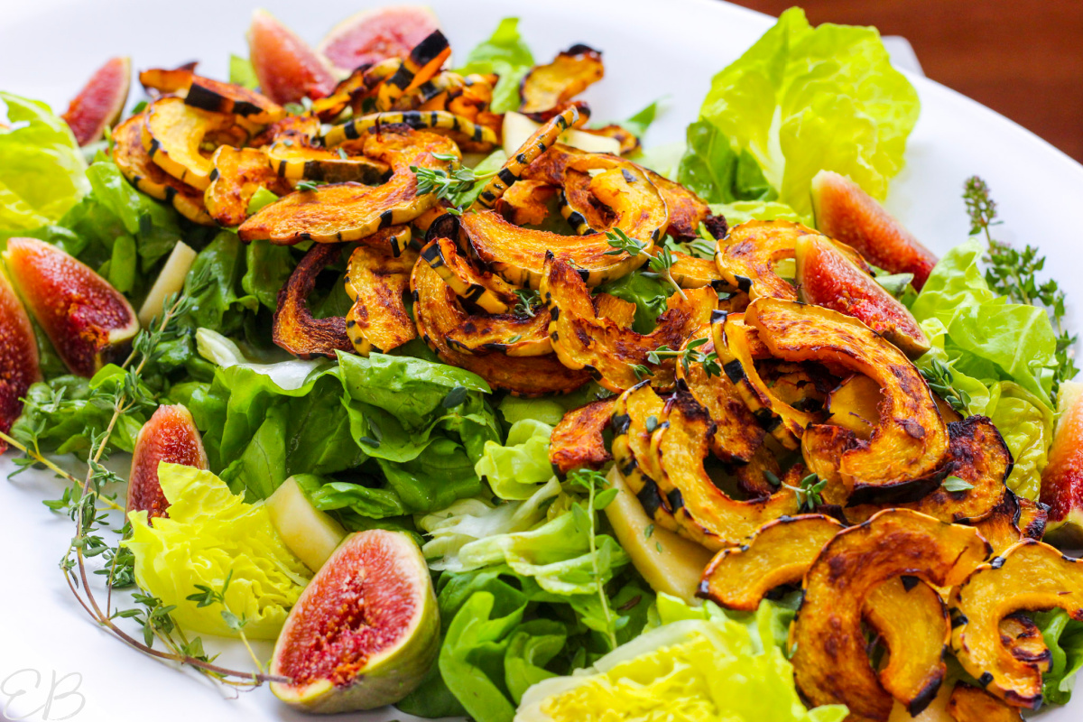 a cascade of roasted delicata squash over dressed lettuce