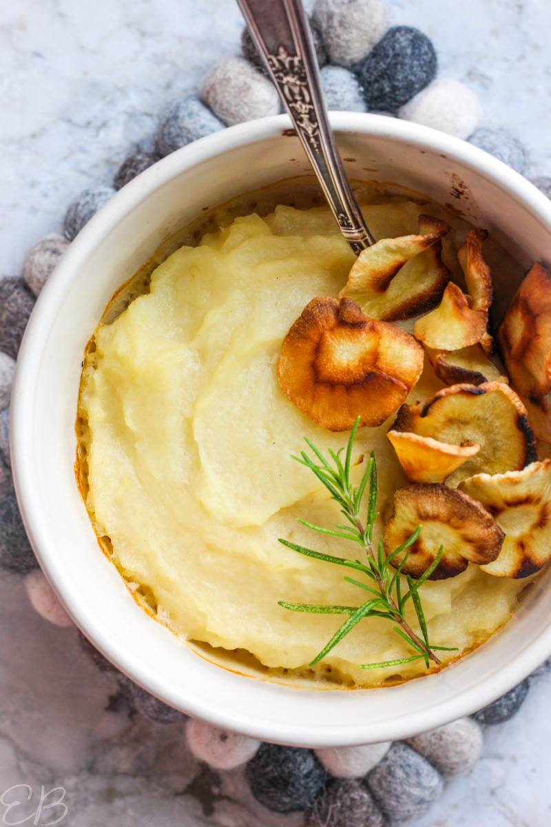 overhead view of parsnip puree gratin in bowl topped with crispy parsnips
