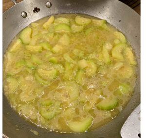 zucchini and broth in cooking pan