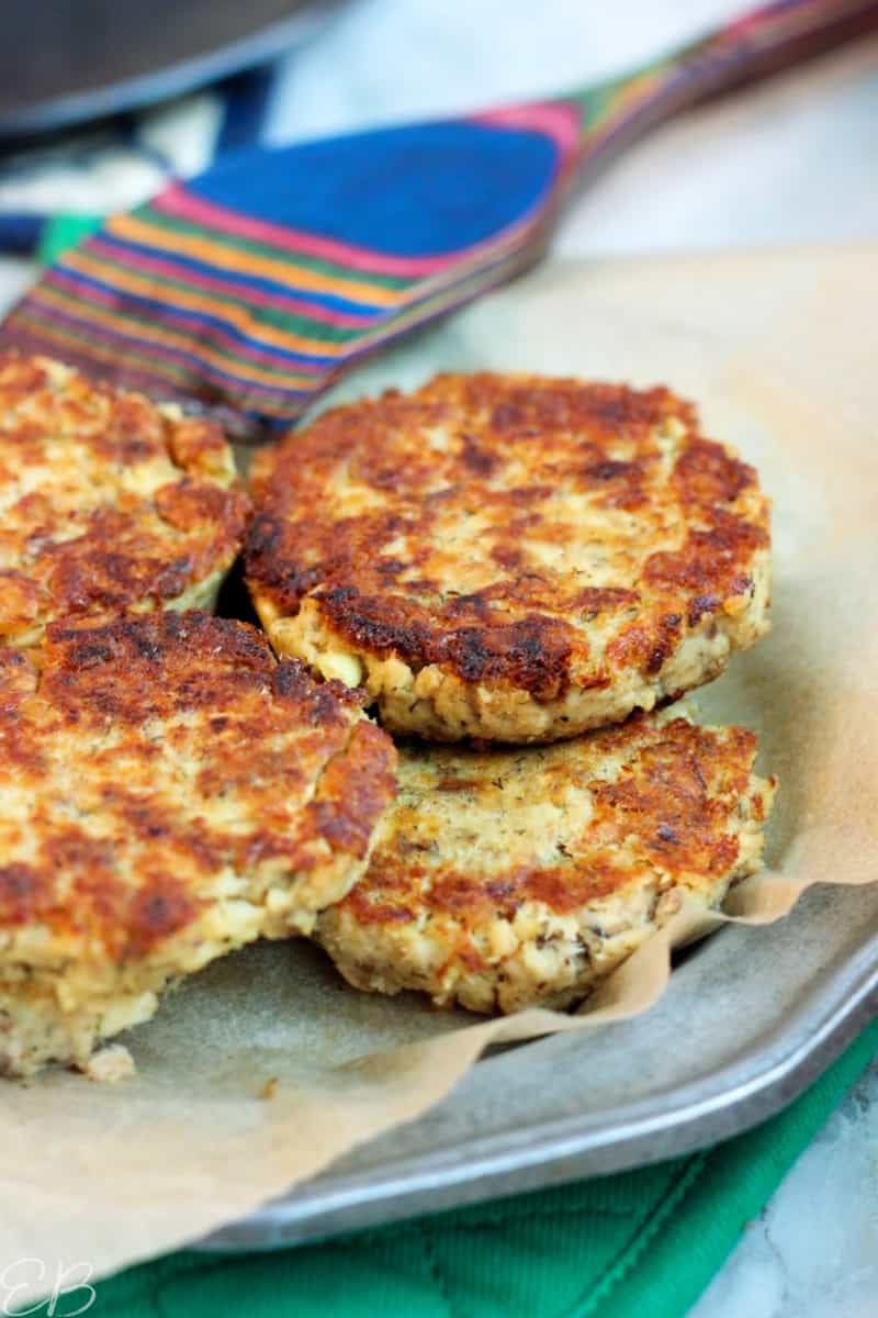 stacked salmon patties on plate with spatula