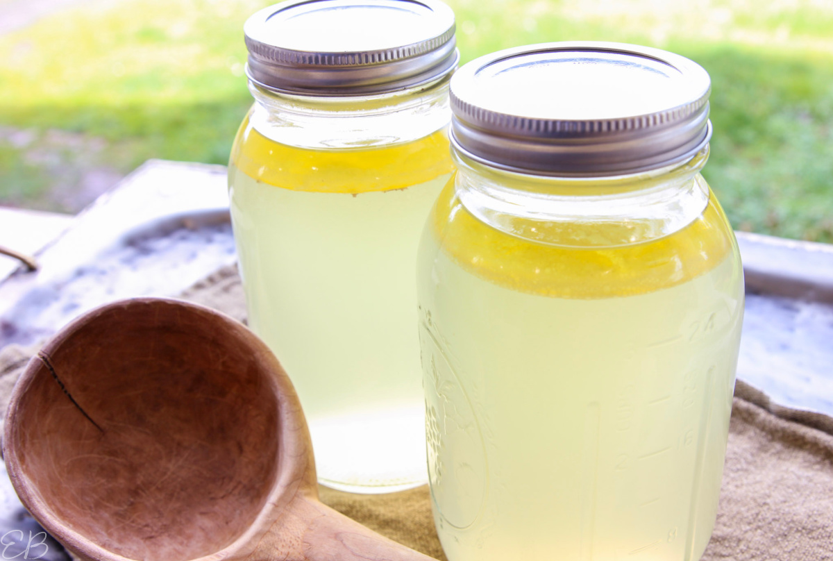 2 jars meat stock with wooden spoon