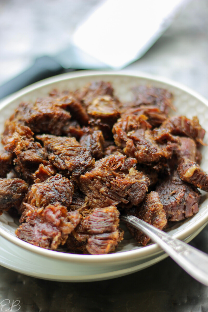 serving spoon in dish of crispy beef from stew meat and spatula