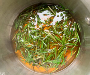 rosemary honey simple syrup process in saucepan