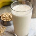 close up shot of oats smoothie for weight loss in clear tall glass