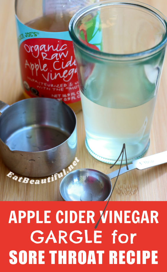glass of water and acv with bottle of apple cider vinegar and measuring tools