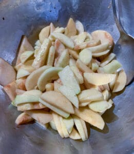 apple slices in mixing bowl