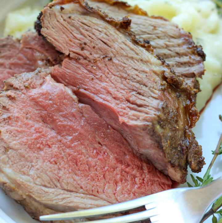 close up photo of sliced boneless leg of lamb roast on plate