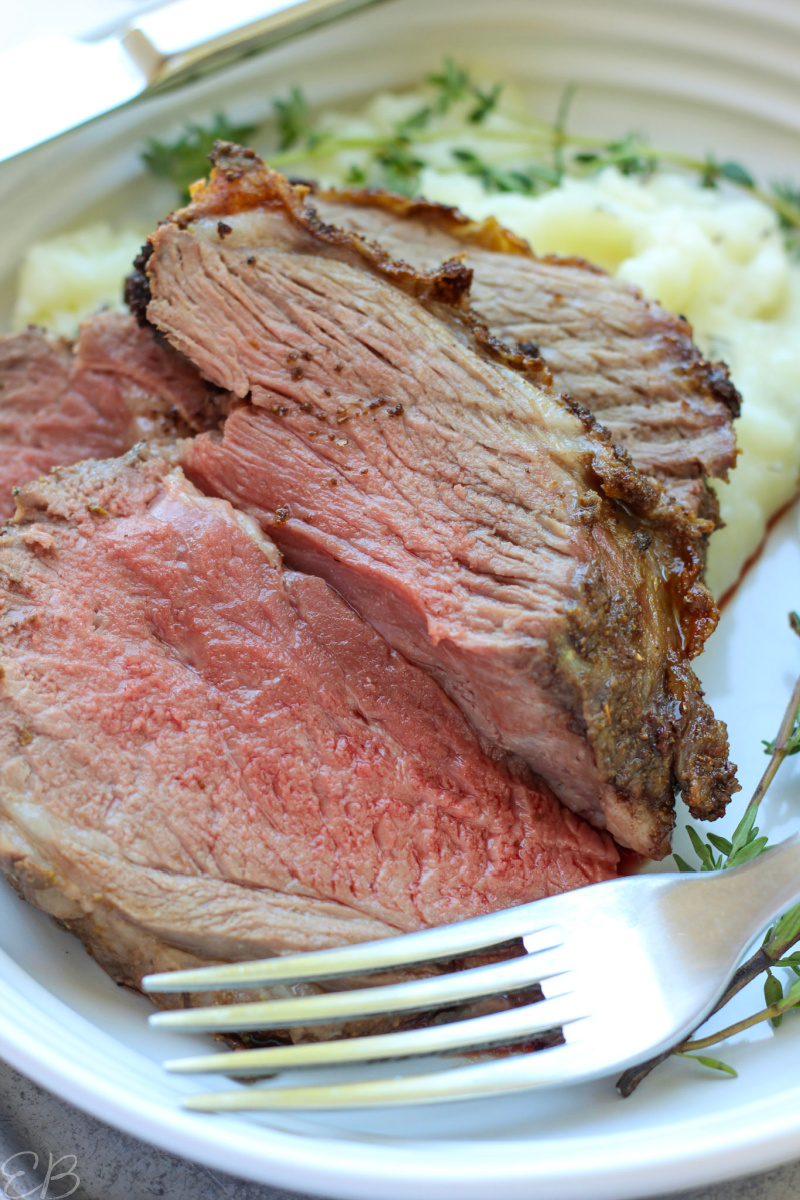 close up photo of sliced boneless leg of lamb roast on plate