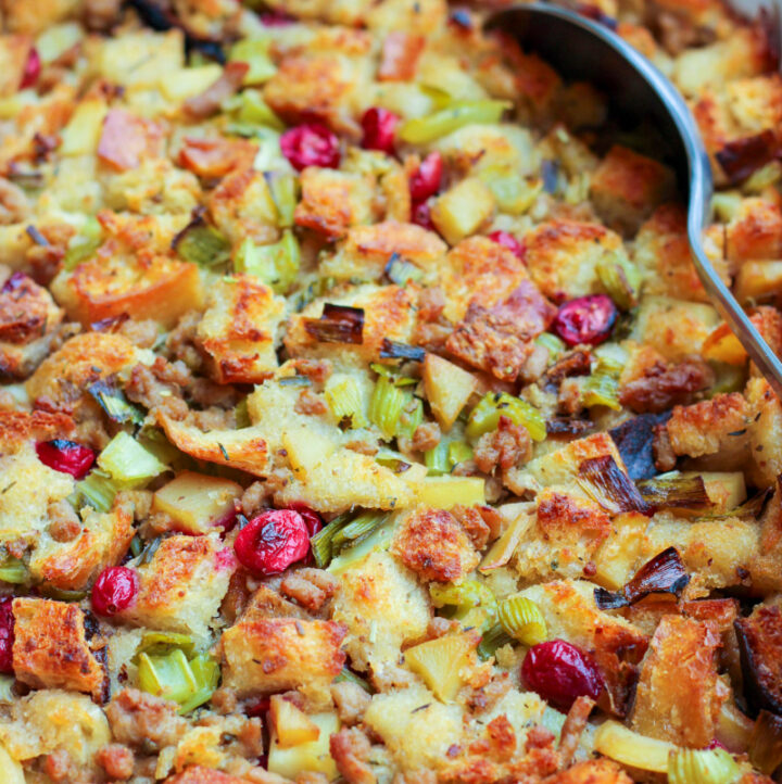 low fodmap sourdough stuffing in serving casserole dish with spoon