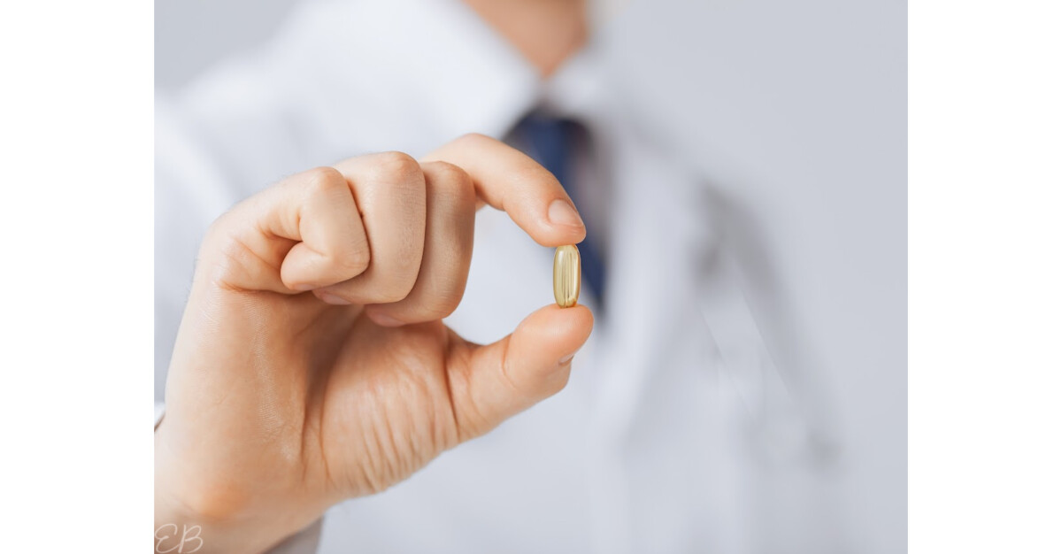 a doctor holding up a fish oil capsule