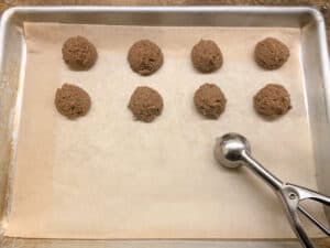 scoops of truffle filling on baking sheet