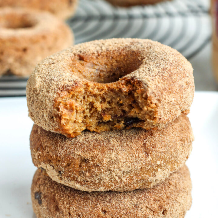 paleo aip donuts stacked with a bite out of the top one
