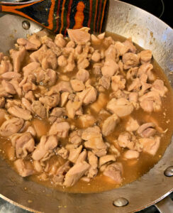 paleo honey ginger chicken in pan almost ready to serve