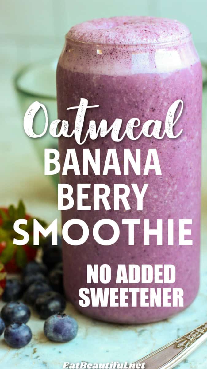 oatmeal banana berry smoothie in tall glass with fresh fruit on the side