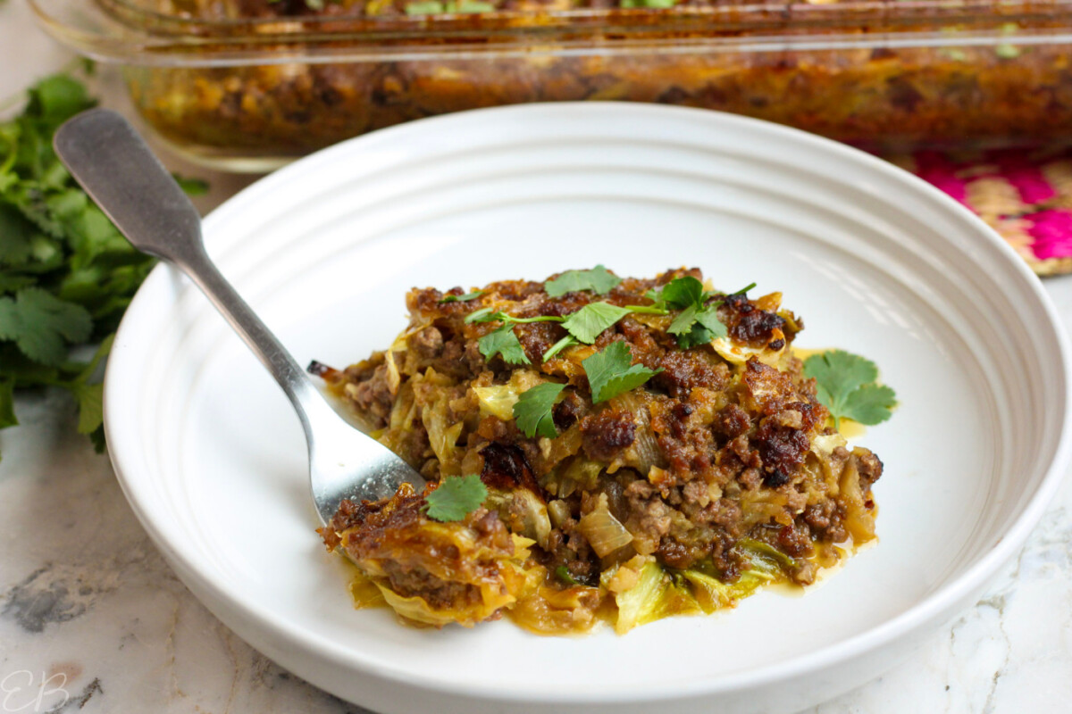 one serving of chinese lazy cabbage roll casserole on white plate with fork
