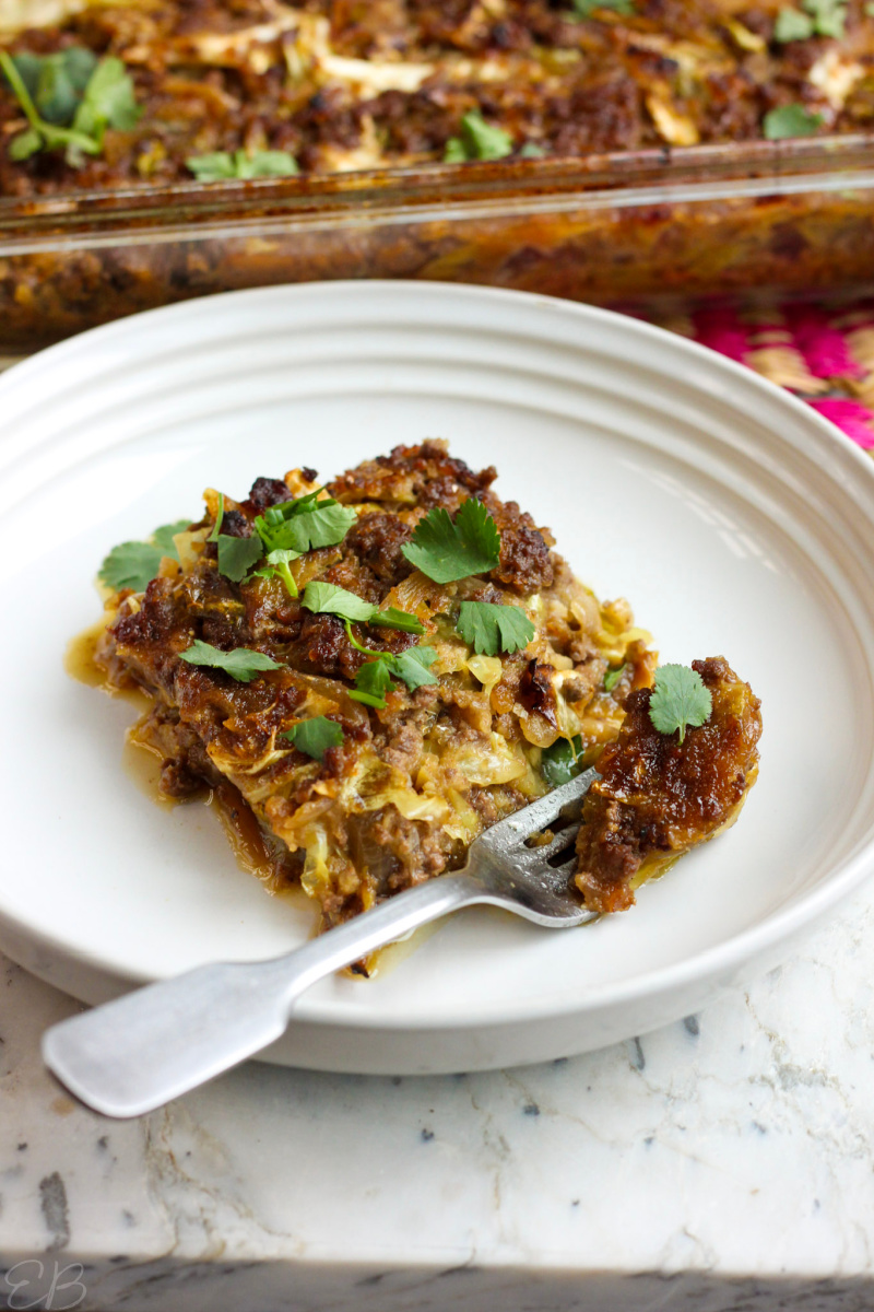 one serving of chinese lazy cabbage roll casserole on white plate with fork