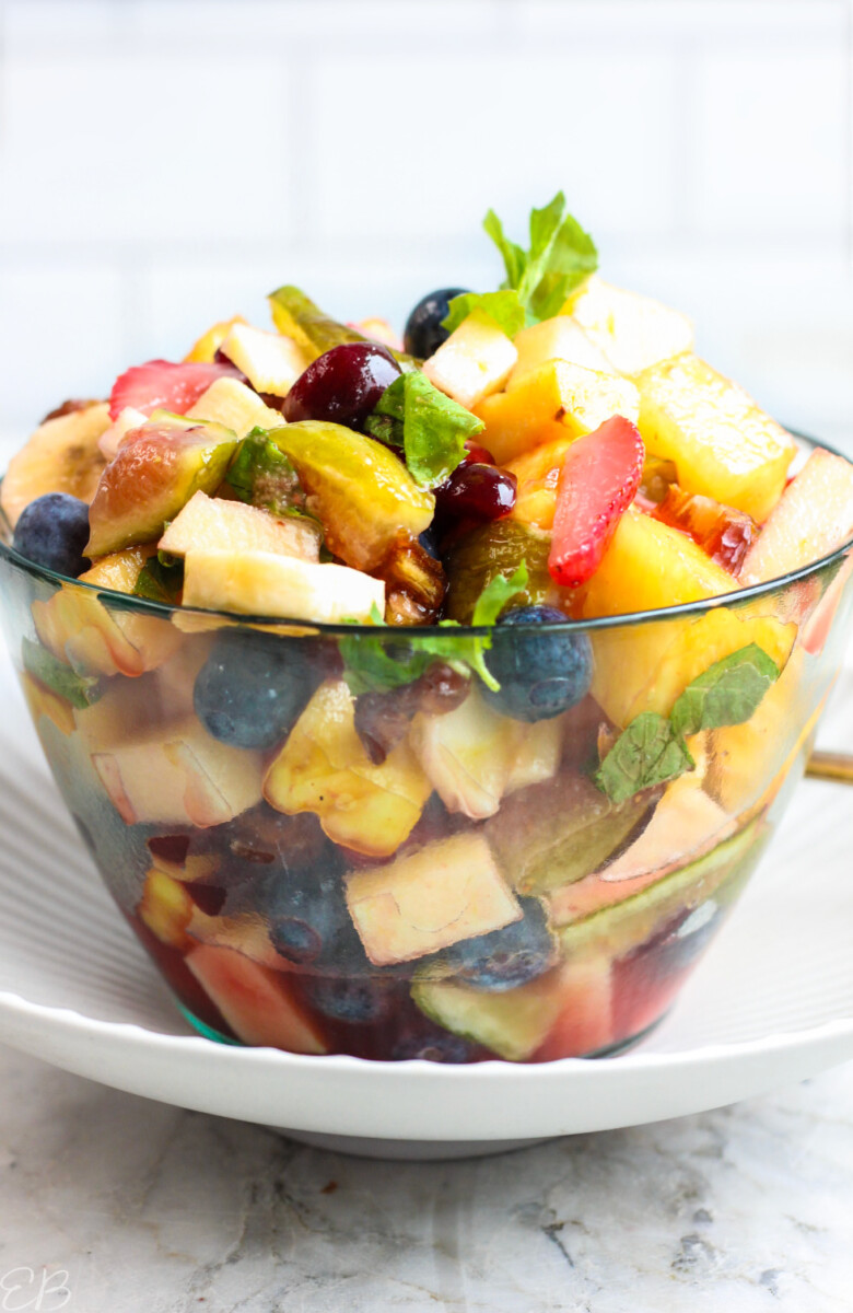 heaping bowl full of low oxalate fruit salad in front of tile backsplash