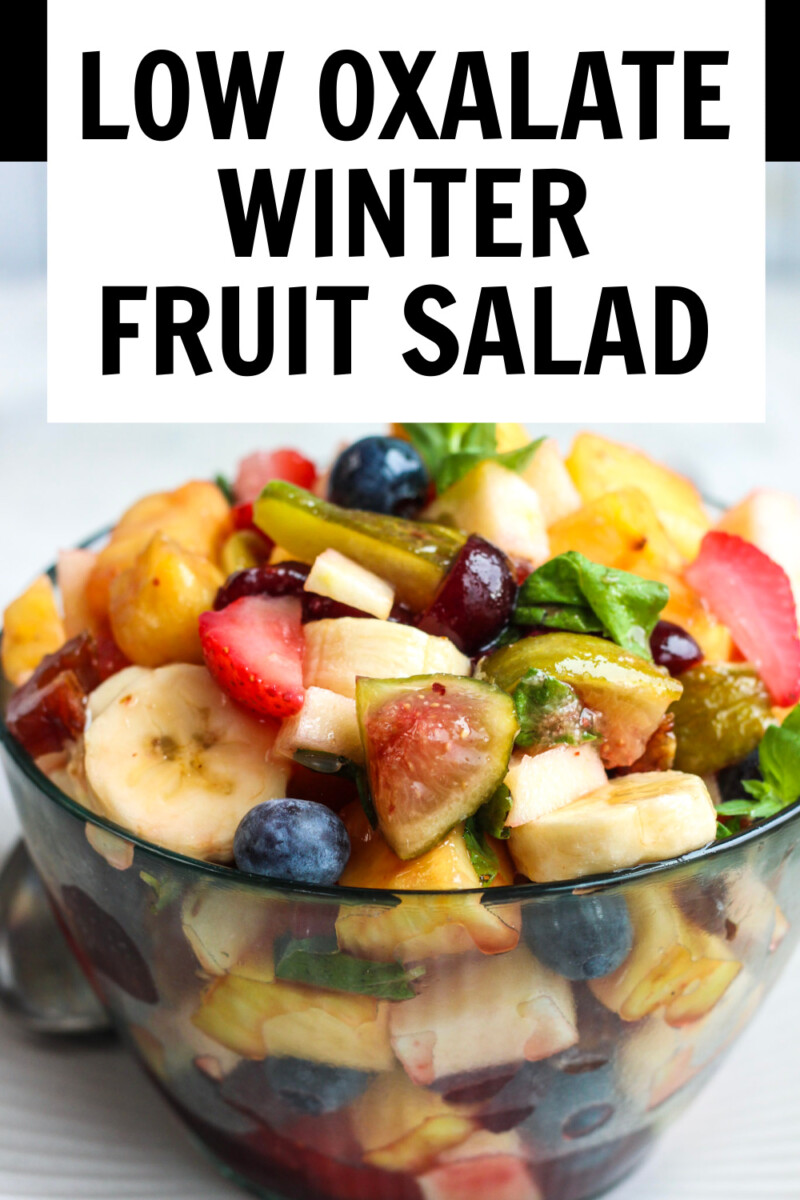 heaping bowl of fruit salad with fresh mint, and title overlay that says, Low Oxalate Winter Fruit Salad