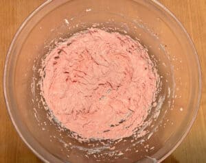 bowl of beaten strawberry frosting