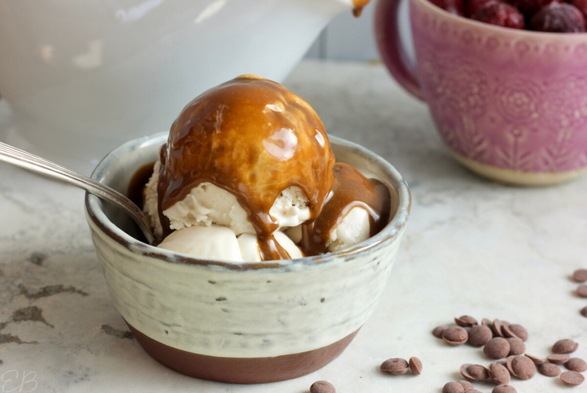 paleo vegan aip tiger nut dessert sauce poured over ice cream in bowl with spoon
