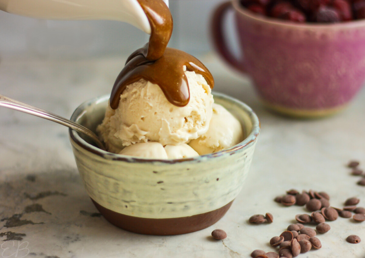 paleo vegan aip tiger nut dessert sauce being poured over ice cream in bowl with spoon, like peanut butter sauce