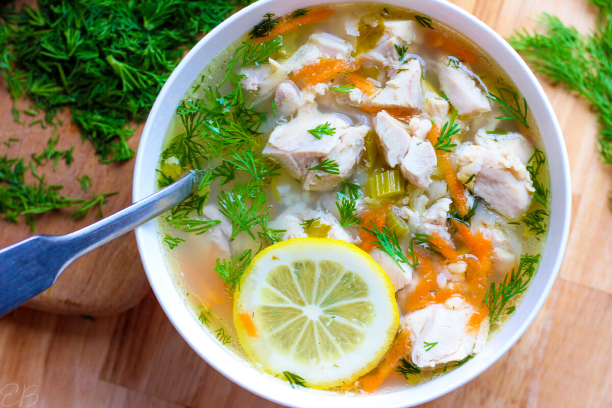overhead view of greek lemon chicken soup in white bowl