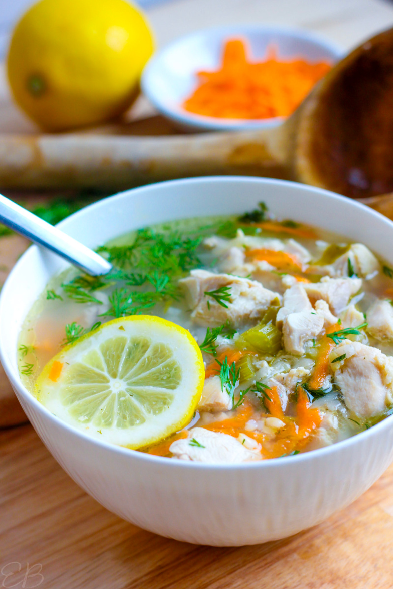 Greek Lemon Chicken Soup in white bowl with spoon