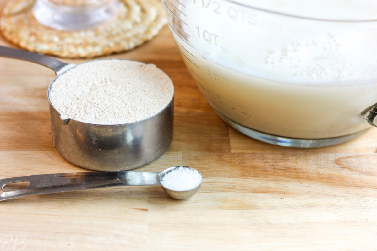 up close photo of oat flour, salt and oat milk strained into bowl