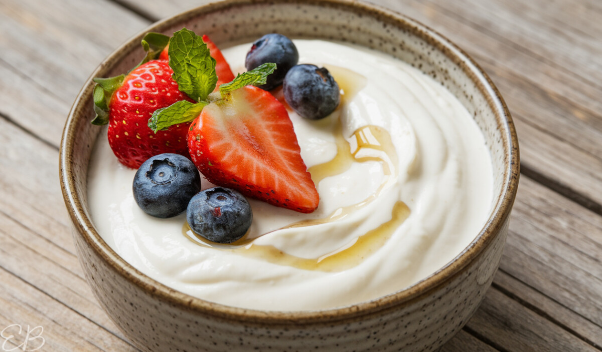 side angle view of homemade instant pot cashew yogurt served in bowl with berries