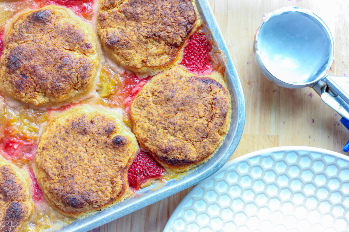 overhead view of baked strawberry rhubarb cobbler fresh from the oven