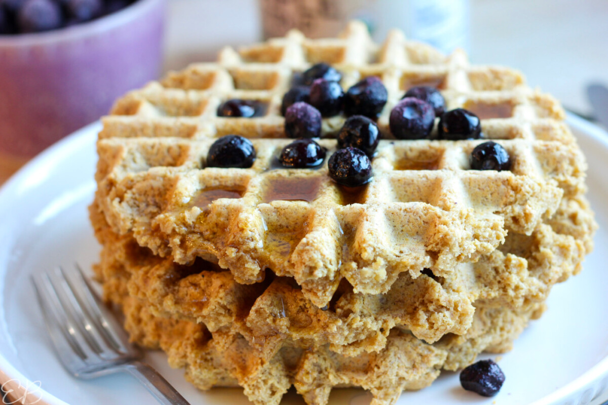 up close photos of stacked gluten free vegan high protein waffles with syrup and berries