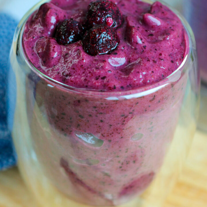 side angle view of best textured healthy blueberry smoothie in glass