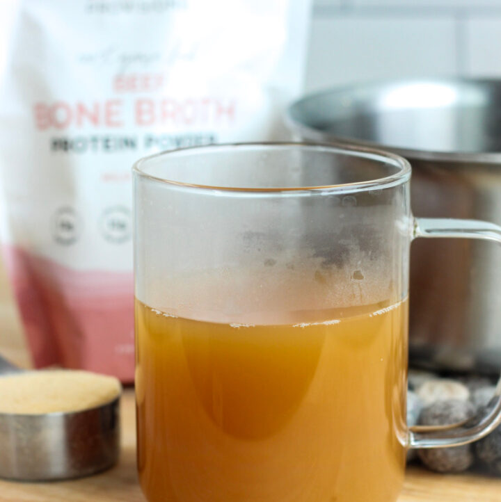 a mug of grass fed bouillon bone broth with product and tools in background