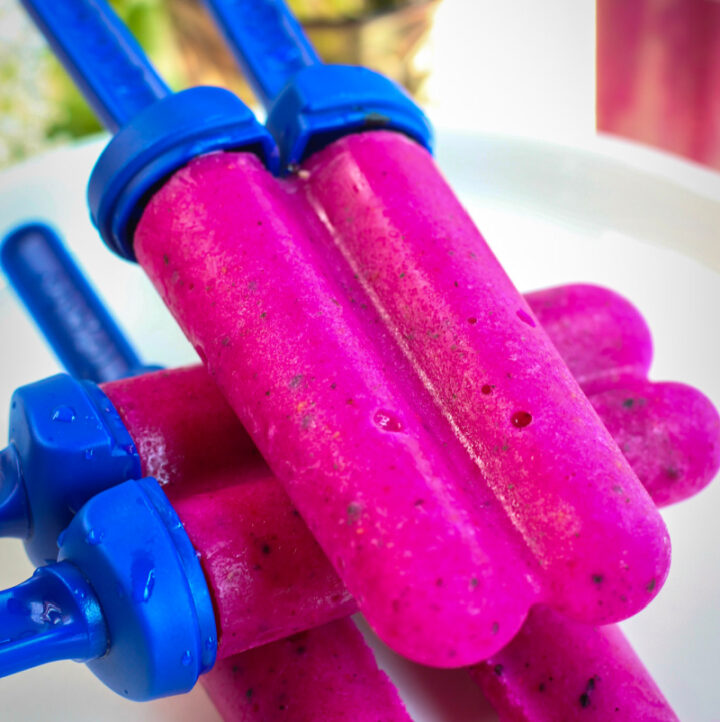 stacked dragon fruit popsicles on white plate