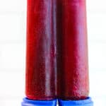 holding up a concord grape juice popsicle