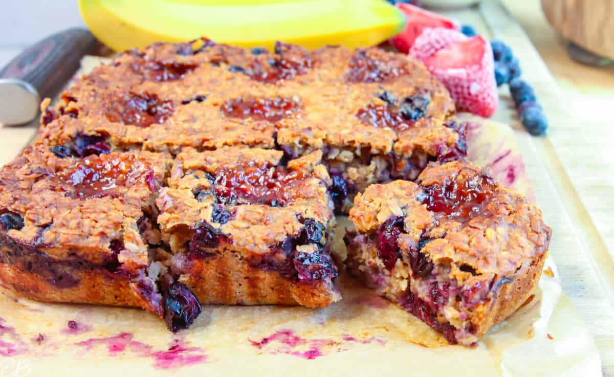 close up baked peanut butter and jelly oatmeal cut into squares to serve