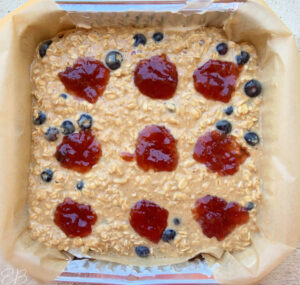 overhead view of baked peanut butter and jelly oatmeal recipe before being baked