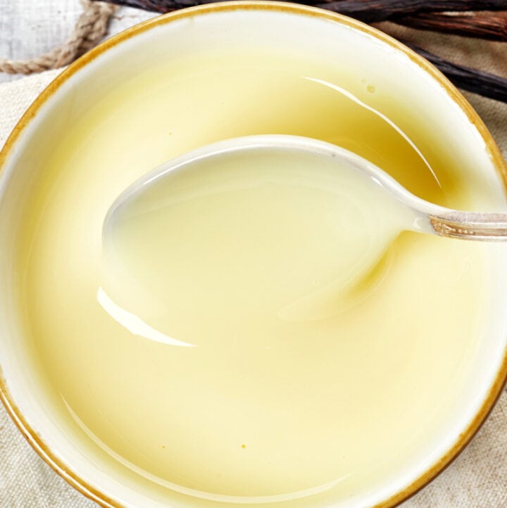 up close warm DF vanilla custard in dish with spoon