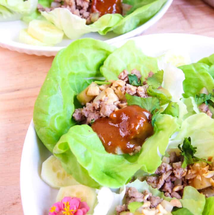 side angle view of Asian Ground Turkey Lettuce Wraps served on white plates