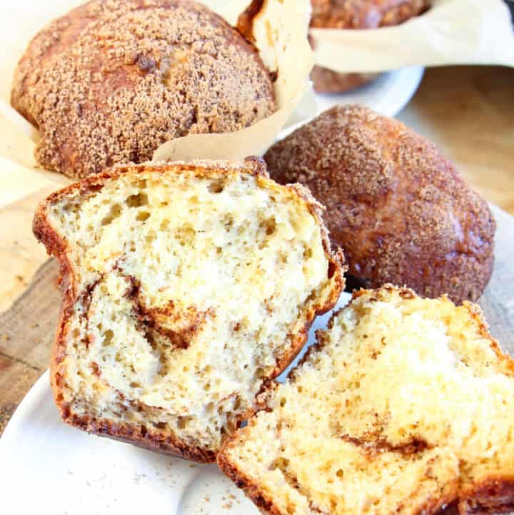 A gluten-free high protein cottage cheese muffin split open to see a cinnamon swirl inside
