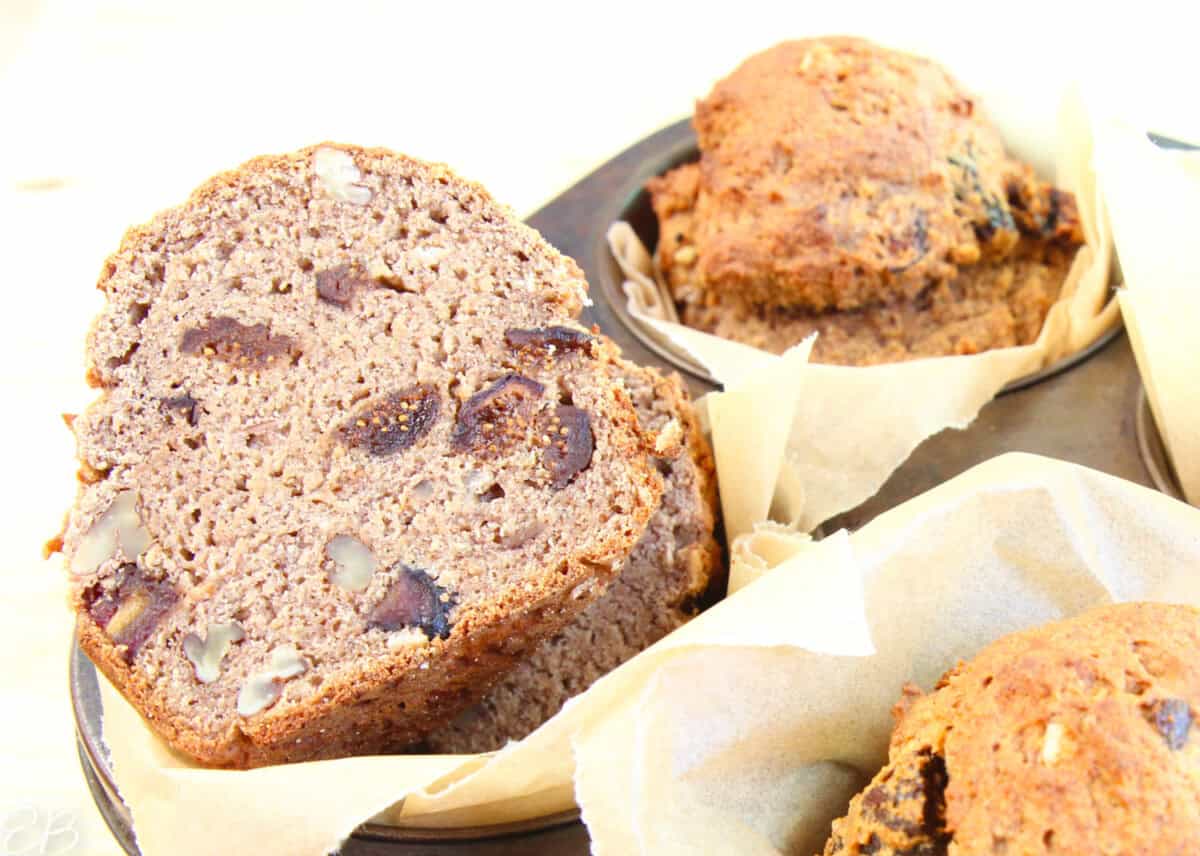 cut open high calcium muffin, showing moist banana crumb and chopped figs and walnuts