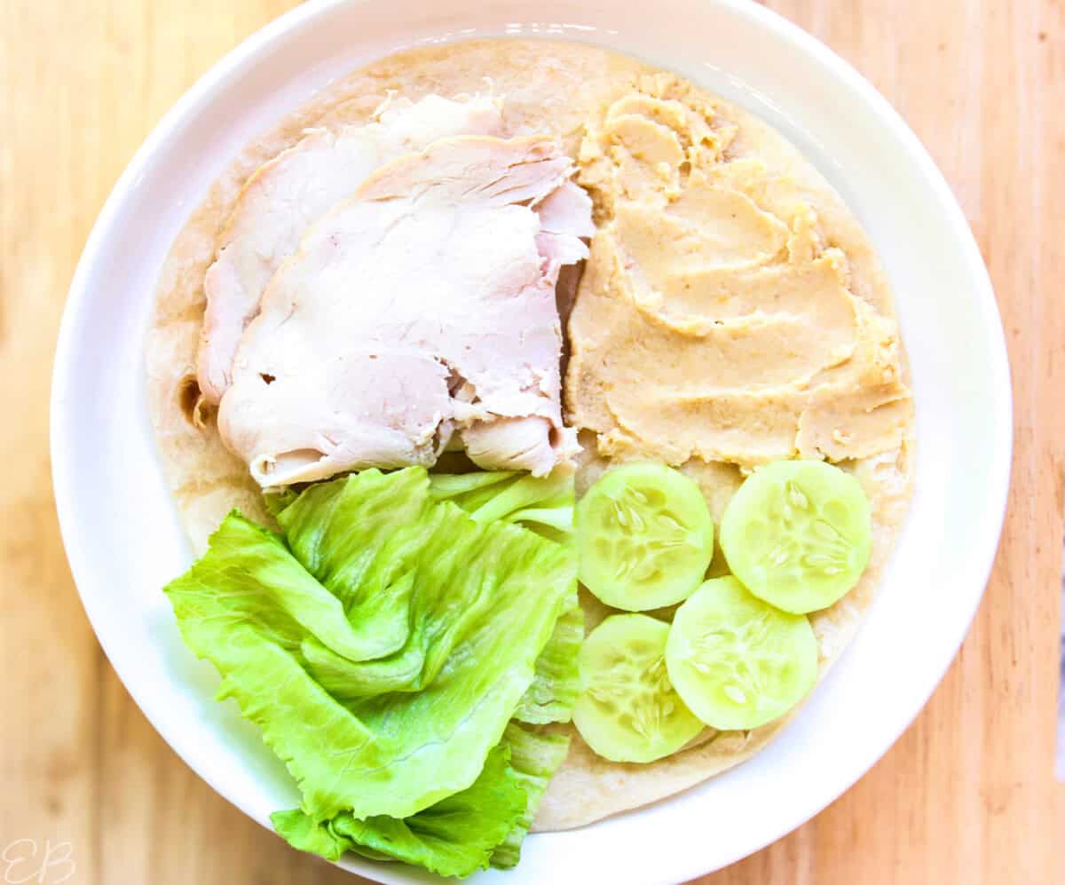 overhead view of turkey, hummus sandwich wrap for kids' lunches, not folded yet