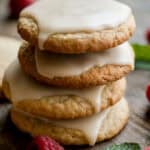 vegan gluten free cut out cookies stacked with icing and holiday garnishes