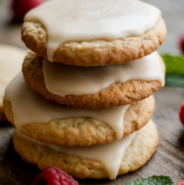 vegan gluten free cut out cookies stacked with icing and holiday garnishes