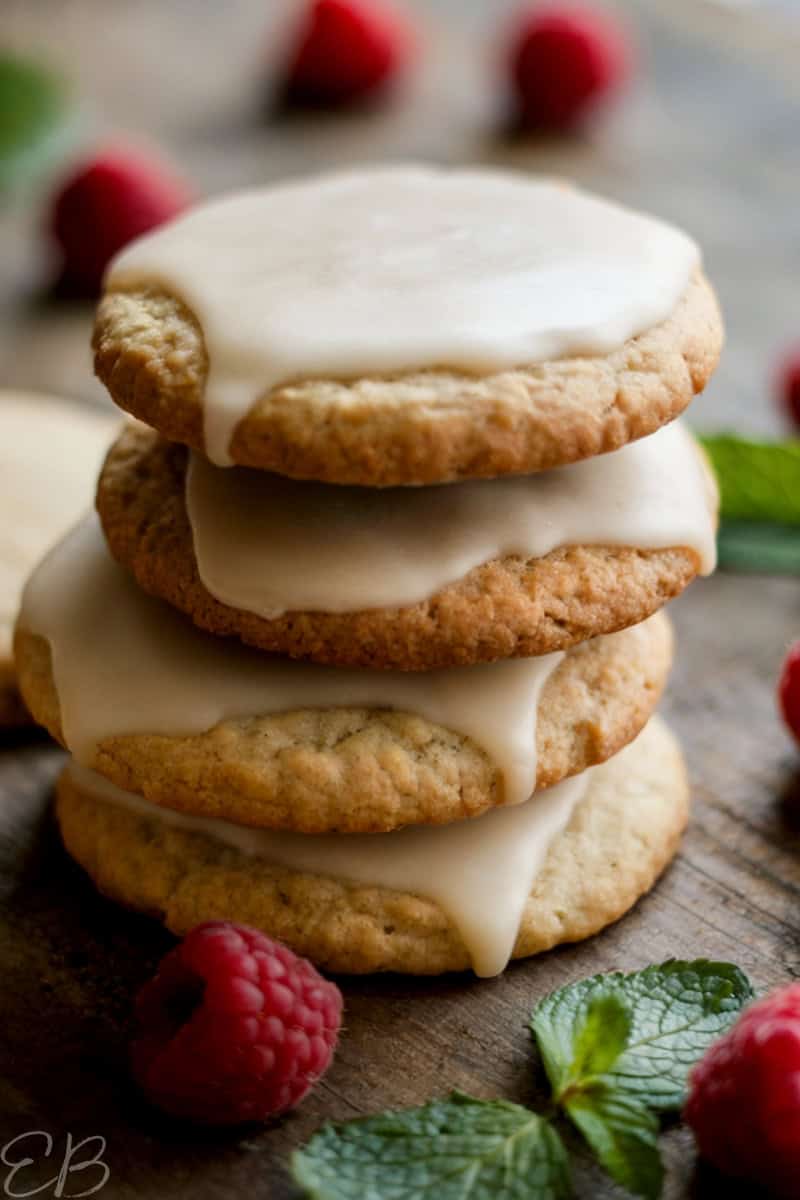 vegan gluten free cut out cookies stacked with icing and holiday garnishes