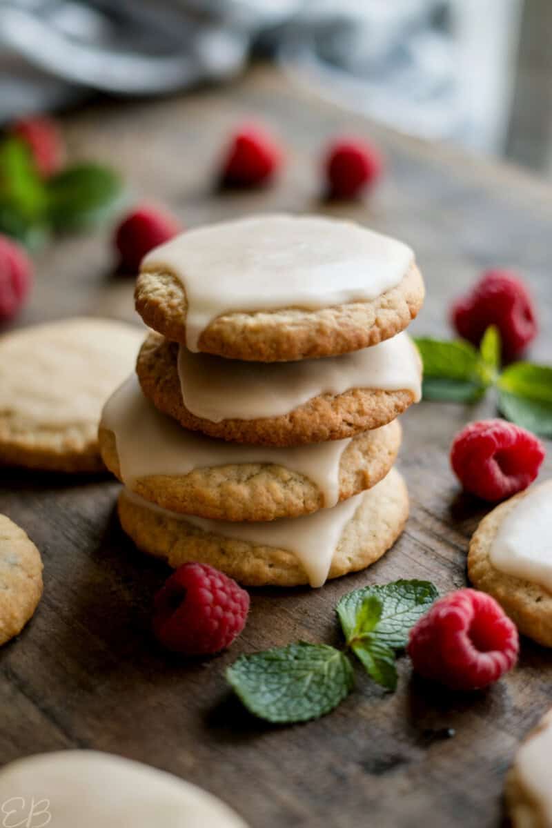 vegan gluten free cut out cookies (made with oat flour) stacked with icing and holiday garnishes